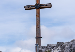 Weathered wooden cross on a rocky ridge